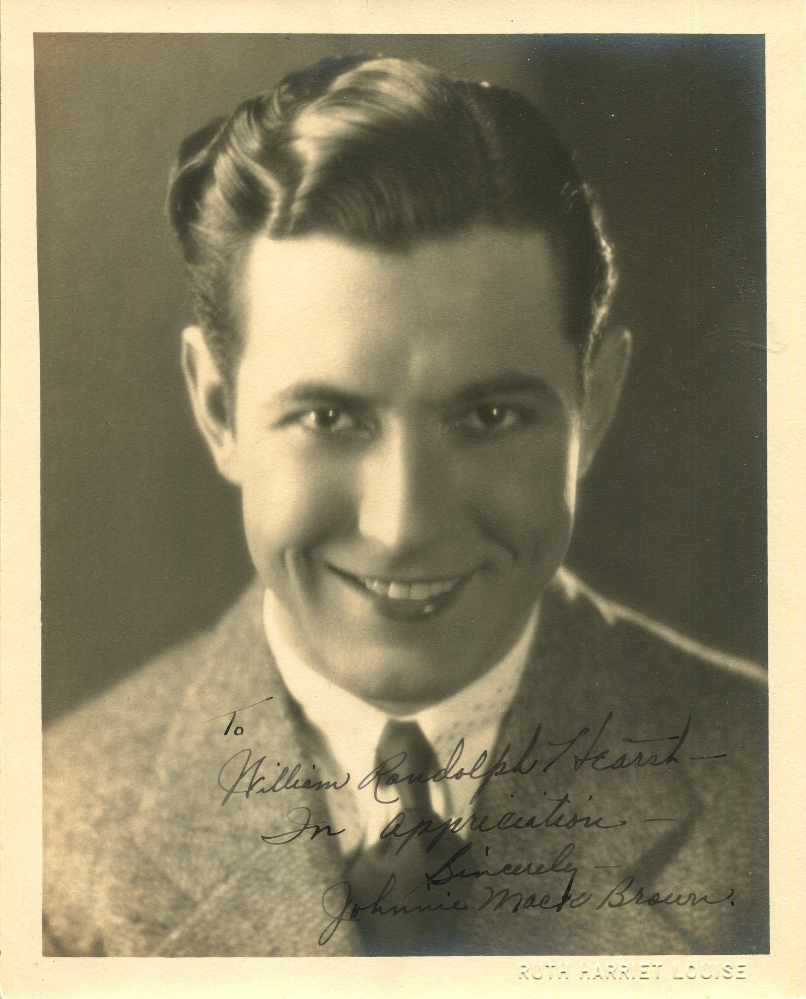 BROWN JOHNNY MACK: (1904-1974): BROWN JOHNNY MACK: (1904-1974) American actor and college football player who mainly starred in Western films. A good vintage signed and inscribed sepia 8 x 10 photograph of Brown in a smiling head