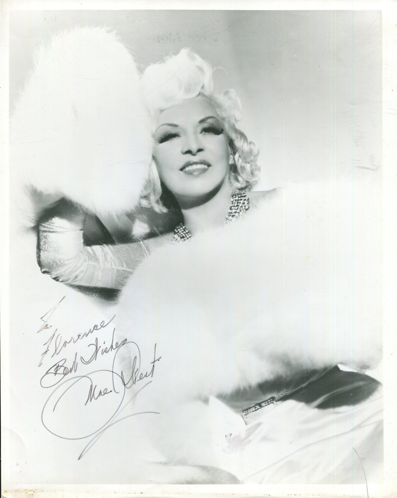 WEST MAE: (1893-1980): WEST MAE: (1893-1980) American actress and sex symbol. Signed and inscribed 8 x 10 photograph of West seated in a glamorous three-quarter length pose. Signed in black ink across a lighter area of the