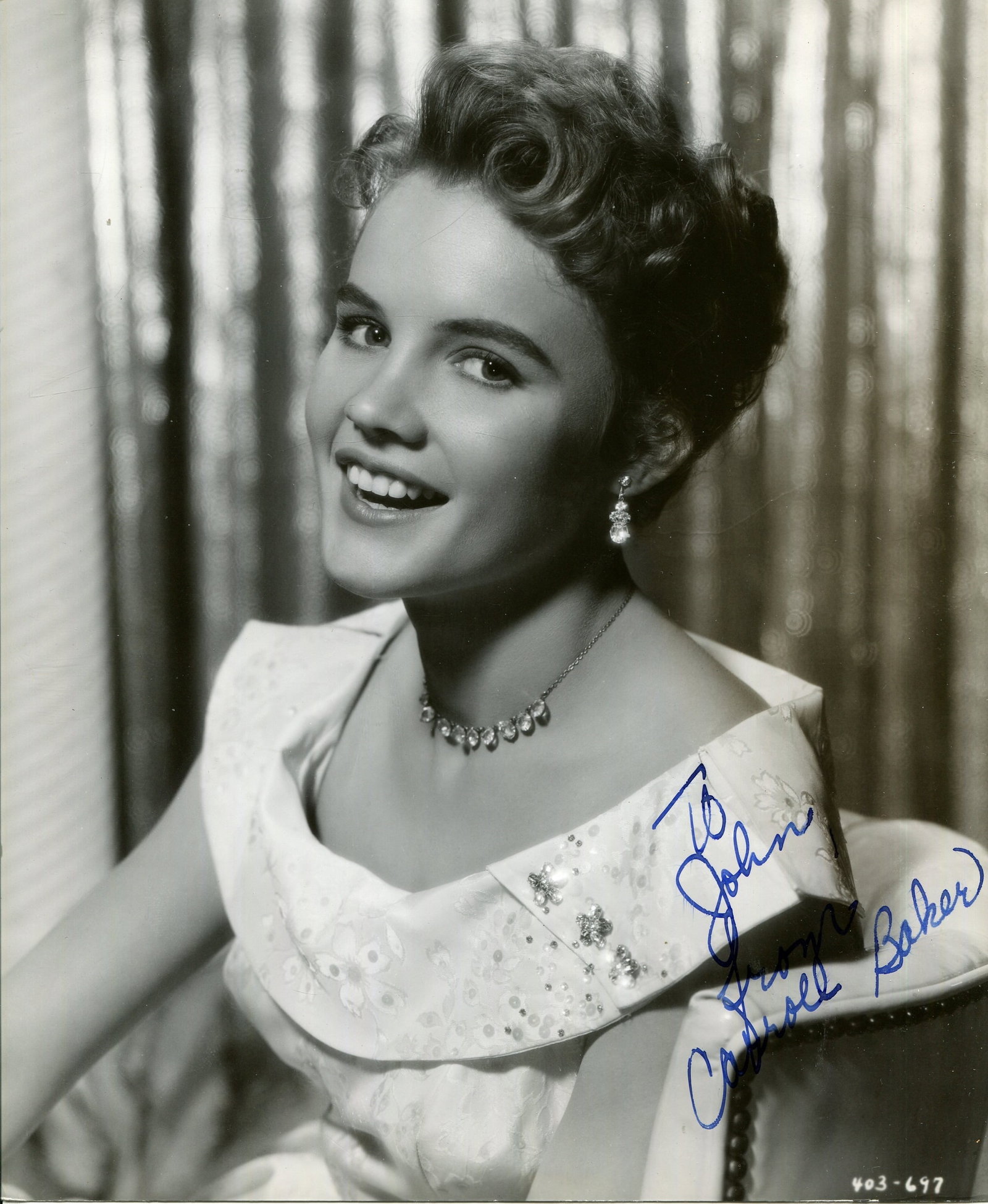 BAKER CARROLL: (1931- ): BAKER CARROLL: (1931- ) American actress. A good vintage signed and inscribed 7.5 x 9 photograph of the young actress in a smiling, vibrant head and shoulders pose. Signed in bold blue fountain pen