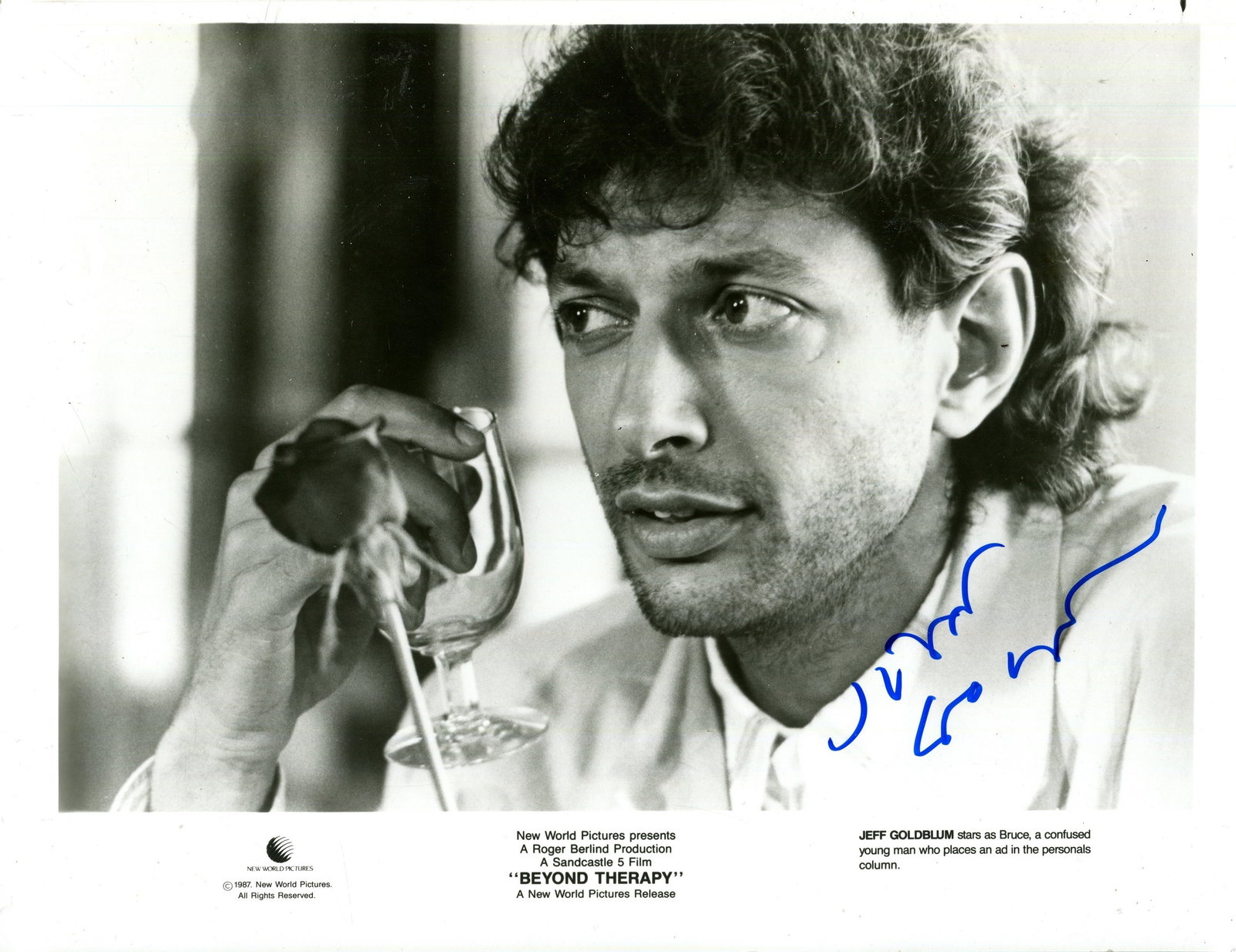 GOLDBLUM JEFF: (1952- ): GOLDBLUM JEFF: (1952- ) American actor. Signed 10 x 8 photograph of the young actor in a head and shoulders pose, in costume as the bisexual Bruce, holding a glass in one raised hand, from the