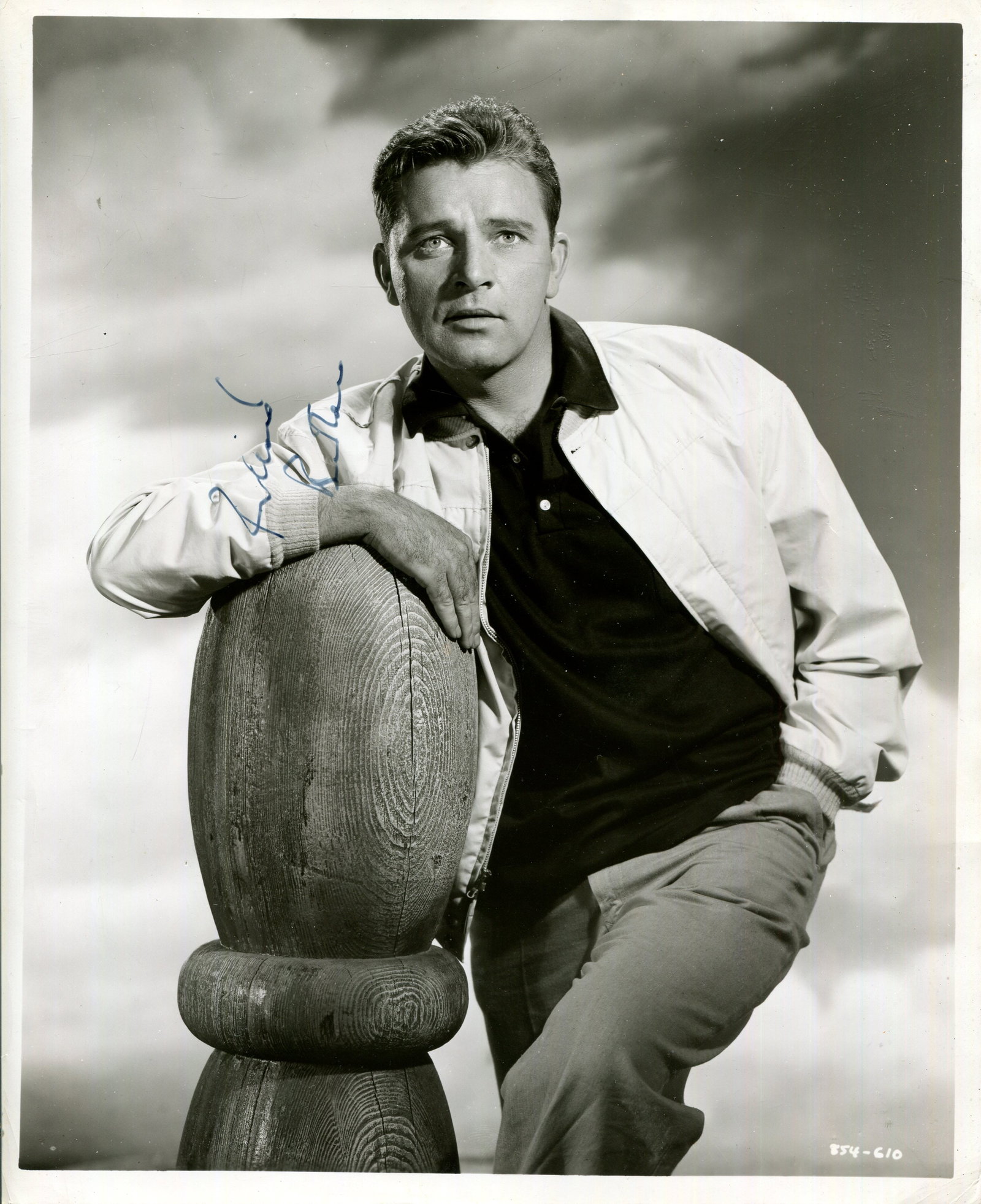 BURTON RICHARD: (1925-1984): BURTON RICHARD: (1925-1984) Welsh actor. Vintage signed 8 x 10 photograph of the young Burton standing in a relaxed three-quarter length pose with one arm resting on a wooden bollard at his side.