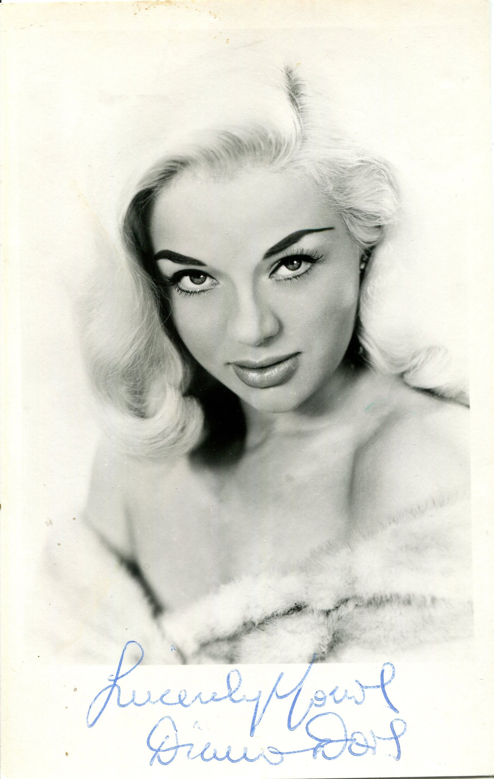 DORS DIANA: (1931-1984): DORS DIANA: (1931-1984) English actress. Vintage signed 3.5 x 5.5 photograph of the blonde actress in a seductive head and shoulders pose. Signed in blue ink to the lower white border. VG