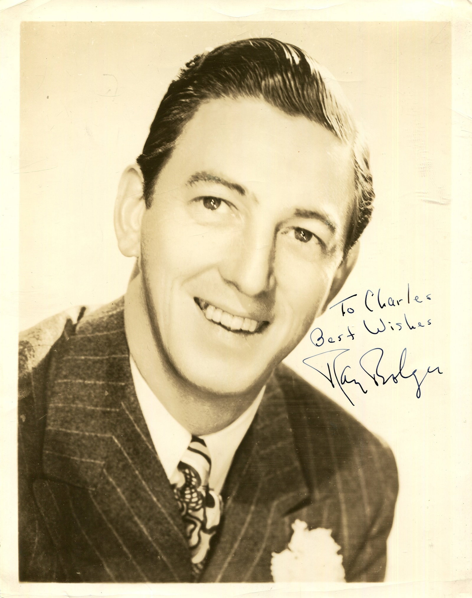 [THE WIZARD OF OZ]: BOLGER RAY (1904-1987): [THE WIZARD OF OZ]: BOLGER RAY (1904-1987) American actor and entertainer, remembered for his role as the Scarecrow in The Wizard of Oz (1939). Signed and inscribed sepia 8 x 10 photograph of Bolger