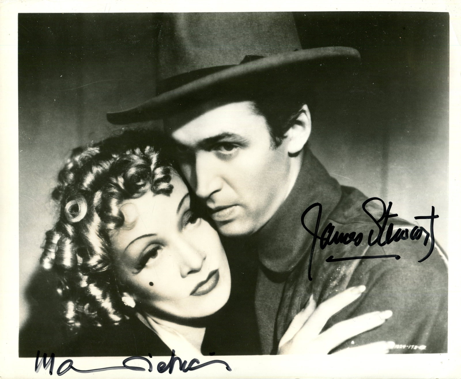 DESTRY RIDES AGAIN:: DESTRY RIDES AGAIN: Signed 10 x 8 photograph by both James Stewart (Thomas Jefferson 'Tom' Destry Jr) and Marlene Dietrich (Frenchy) individually, the image depicting the two actors in a head and