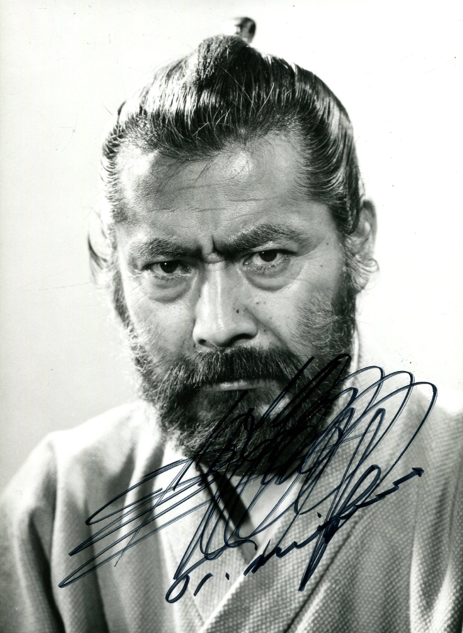 MIFUNE TOSHIRO: (1920-1997): MIFUNE TOSHIRO: (1920-1997) Japanese actor, famous for his roles in Akira Kurosawa’s jidaigeki films. Signed 5 x 6.5 photograph of Mifune in a head and shoulders pose in costume as a samurai.