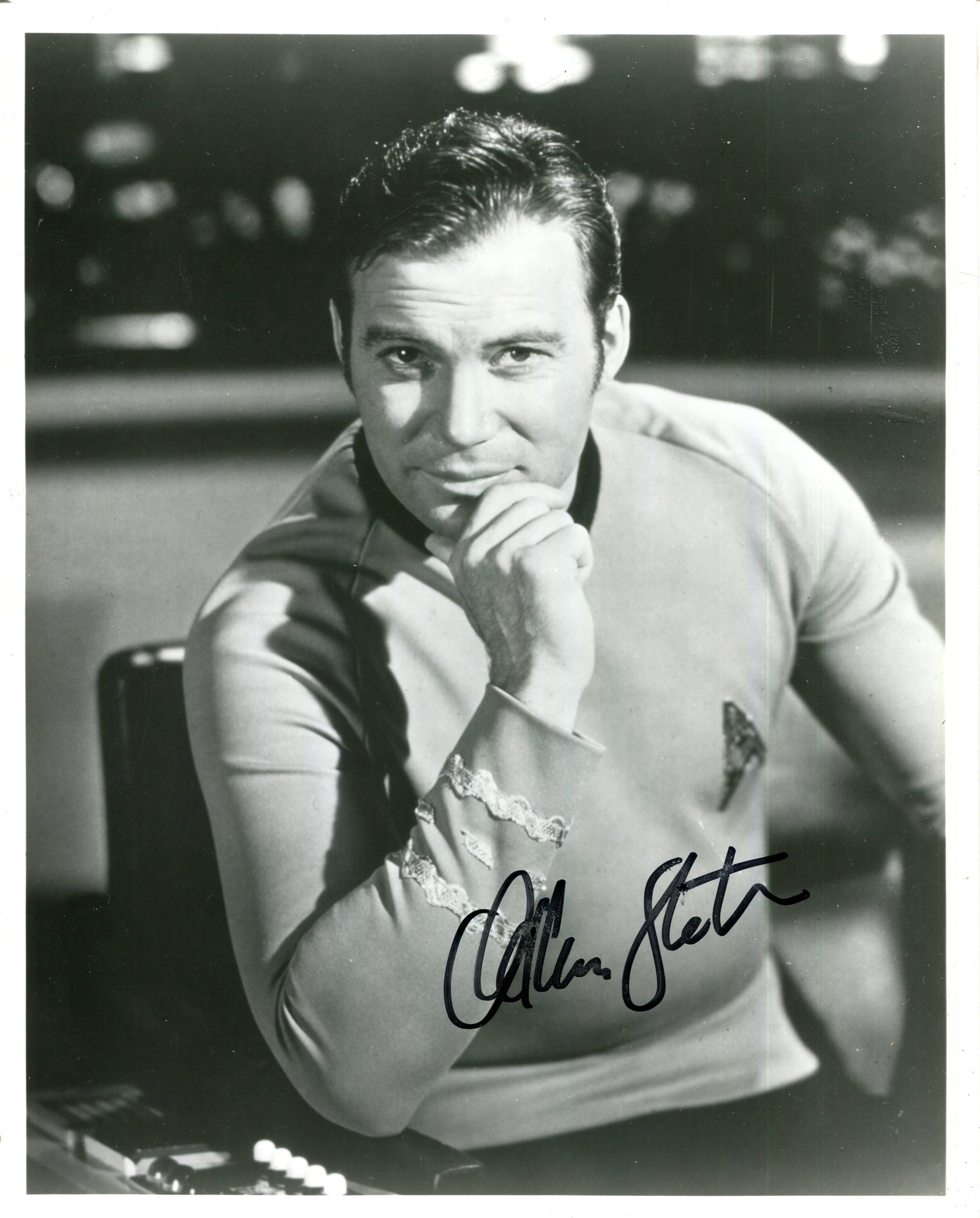 SHATNER WILLIAM: (1931- ): SHATNER WILLIAM: (1931- ) Canadian actor. Signed 8 x 10 photograph of Shatner seated in a half-length pose, in costume from his most famous role as Captain James T. Kirk, on board the starship USS