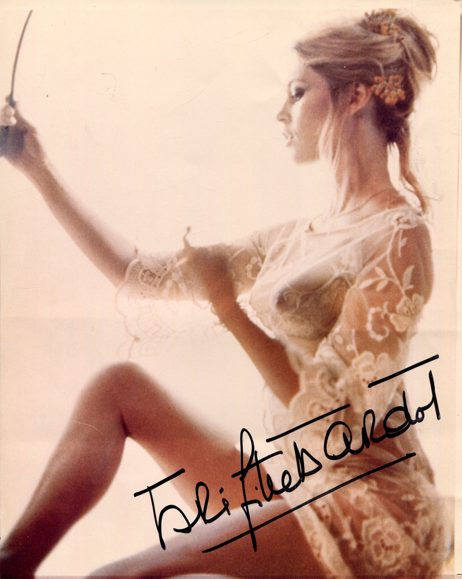 BARDOT BRIGITTE: (1934-2025): BARDOT BRIGITTE: (1934-2025) French actress and sex symbol. Signed colour 8 x 10 photograph of BB seated in a three-quarter length profile pose wearing see-through negligee and holding a hand mirror