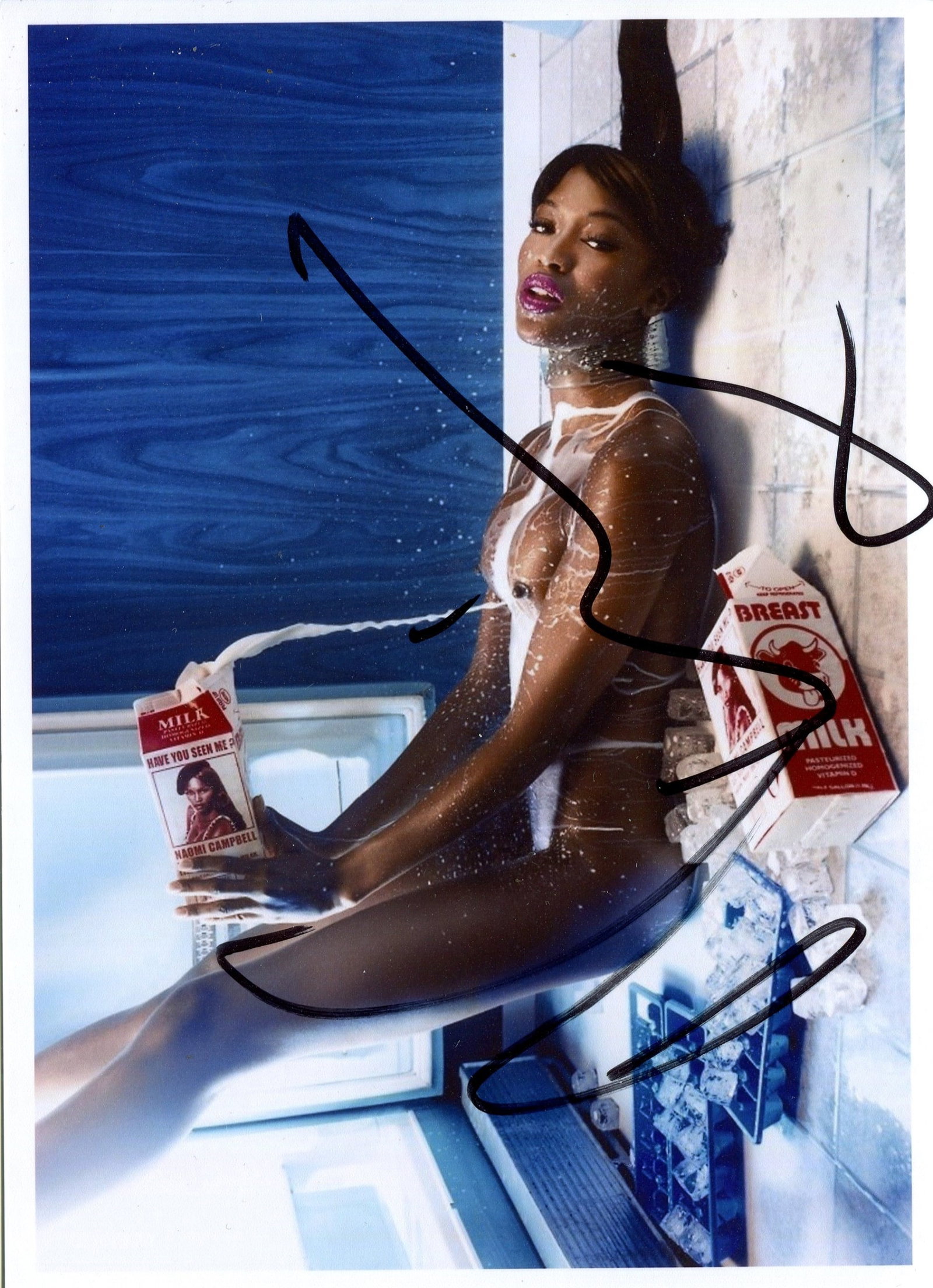 CAMPBELL NAOMI: (1970- ): CAMPBELL NAOMI: (1970- ) British Model. Signed colour 7 x 5 photograph of Campbell, the artistic and sensual image showing the British model lying on the floor in a three-quarter naked pose, pouring