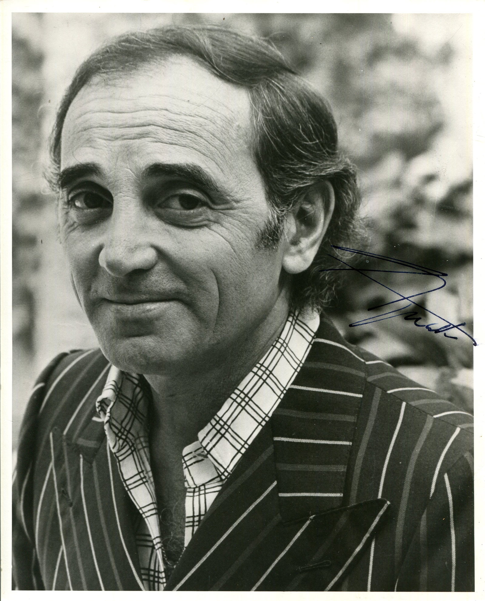 AZNAVOUR CHARLES: (1924-2018): AZNAVOUR CHARLES: (1924-2018) French singer and songwriter. Signed 8 x 10 photograph of Aznavour in an engaging head and shoulders pose. Signed in blue fountain pen ink with his name alone to the