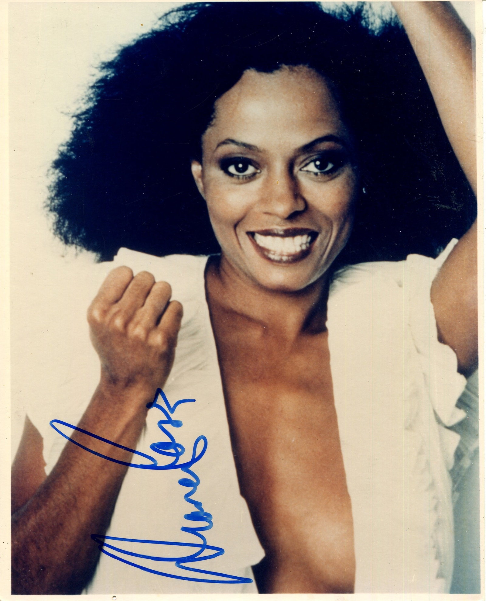 ROSS DIANA: (1944- ): ROSS DIANA: (1944- ) American singer and actress. Signed colour 8 x 10 photograph of Ross in an energetic half-length pose. Signed in bold blue ink with her name alone to a lighter area of the image.