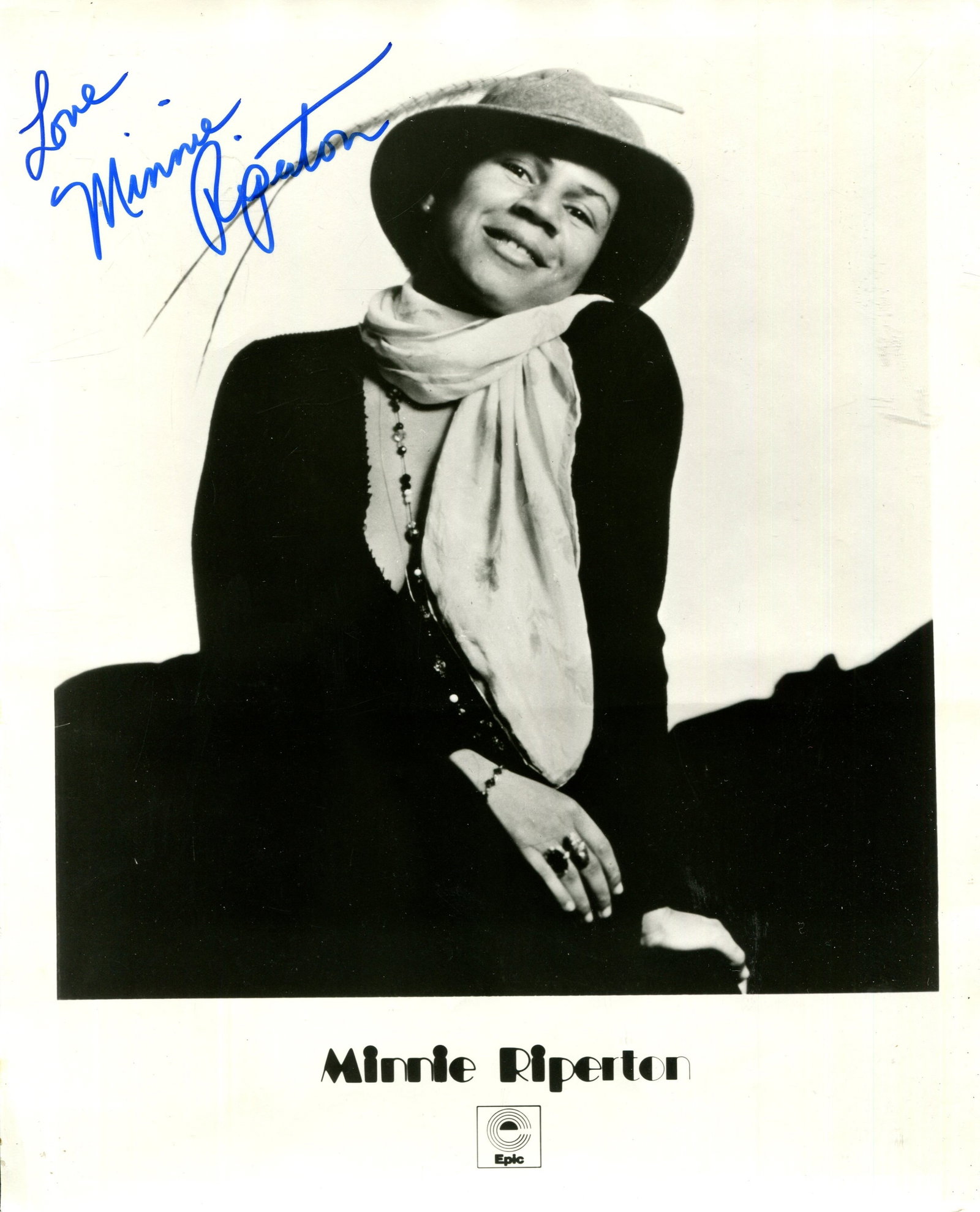 RIPERTON MINNIE: (1947-1979): RIPERTON MINNIE: (1947-1979) American soul singer, best known for her single Lovin´ You (1974). A rare signed 8 x 10 photograph of Riperton seated in a three-quarter length pose wearing a hat and