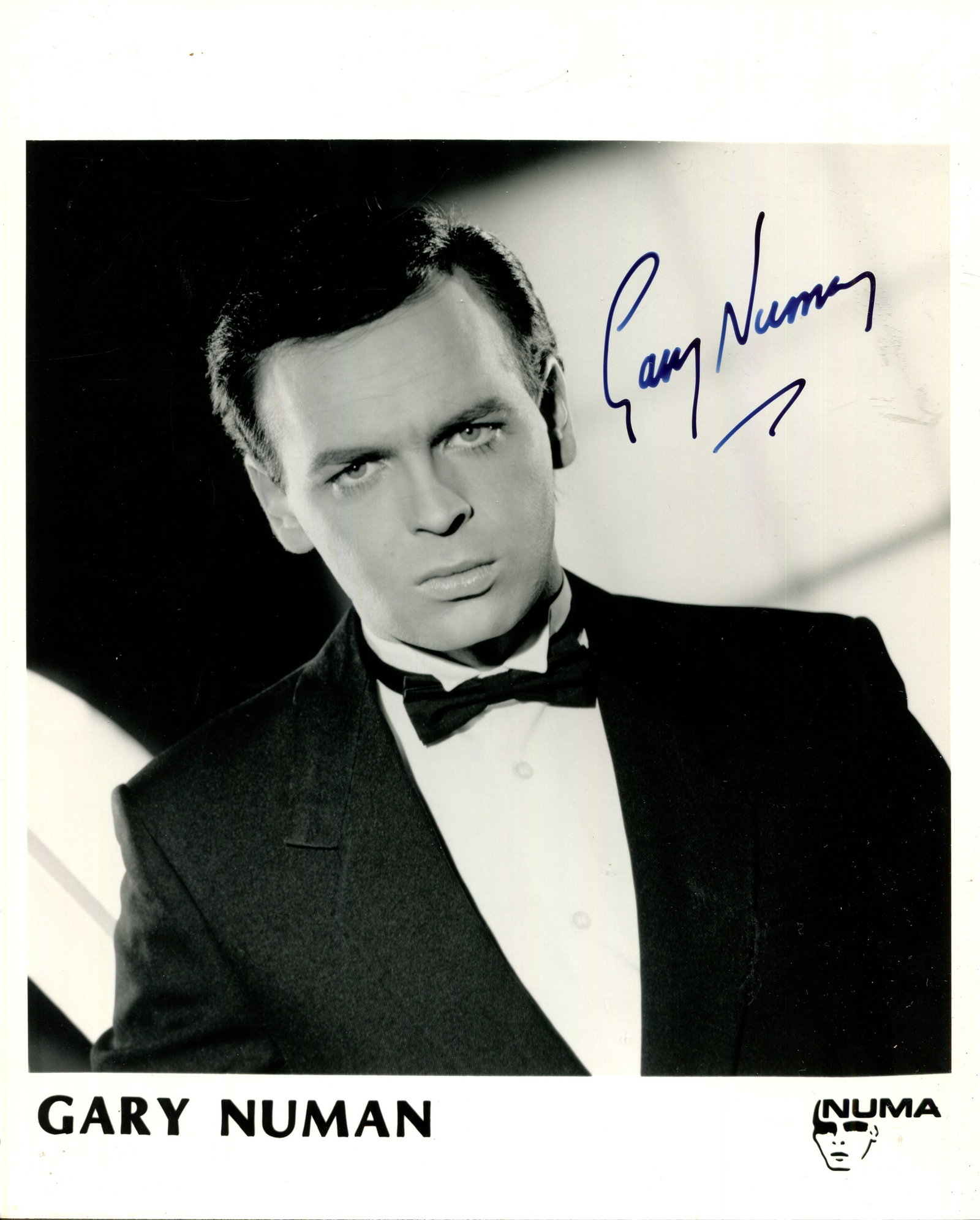 NUMAN GARY: (1958- ): NUMAN GARY: (1958- ) English singer and musician, a pioneer of electronic music and the frontman of the new wave band Tubeway Army. Signed 8 x 10 photograph of Numan in a head and shoulders pose