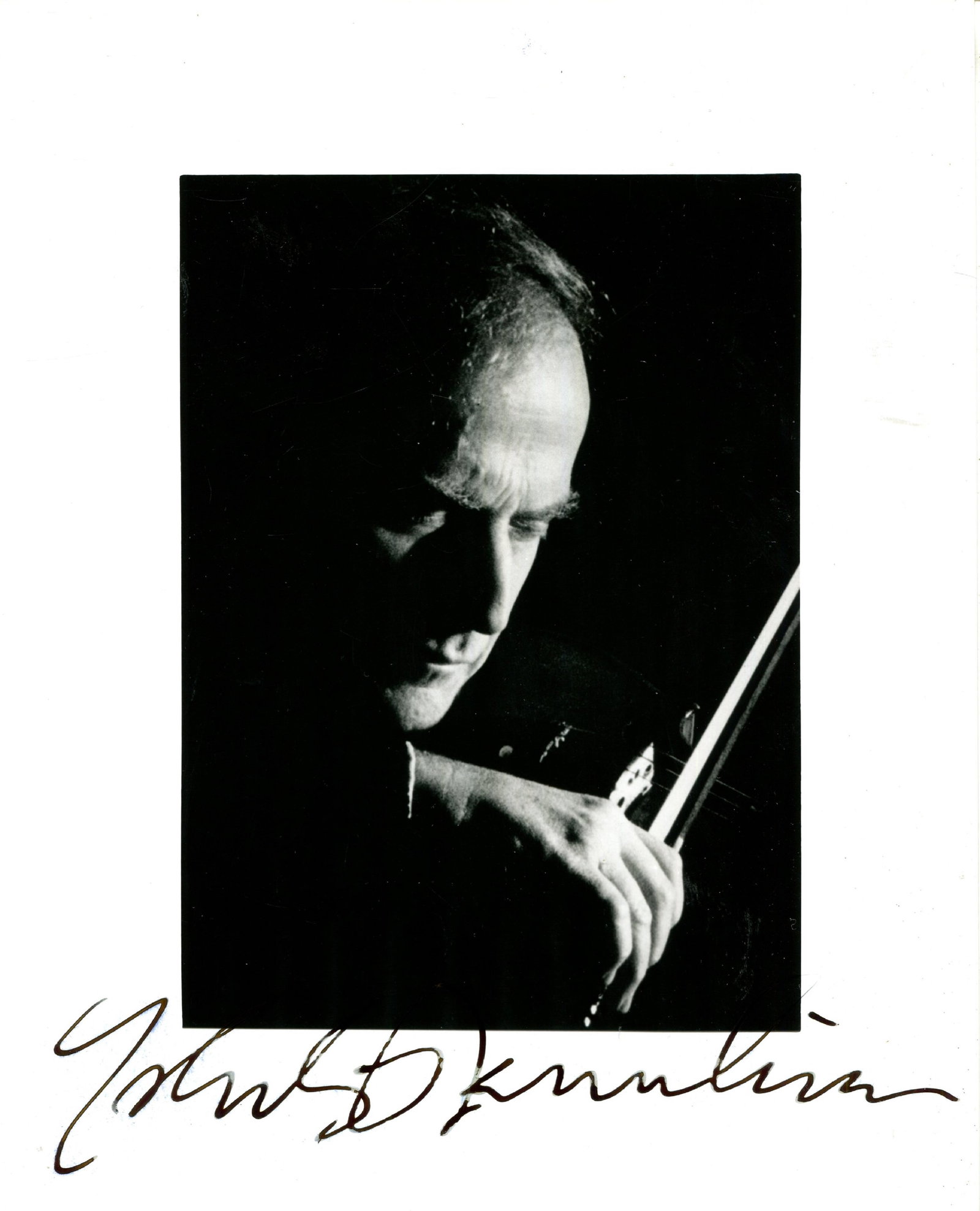 MENUHIN YEHUDI: (1916-1999): MENUHIN YEHUDI: (1916-1999) American-born British violinist. Signed 8 x 10 photograph, an atmospheric image of the musician in a head and shoulders pose playing his violin. Signed in bold black