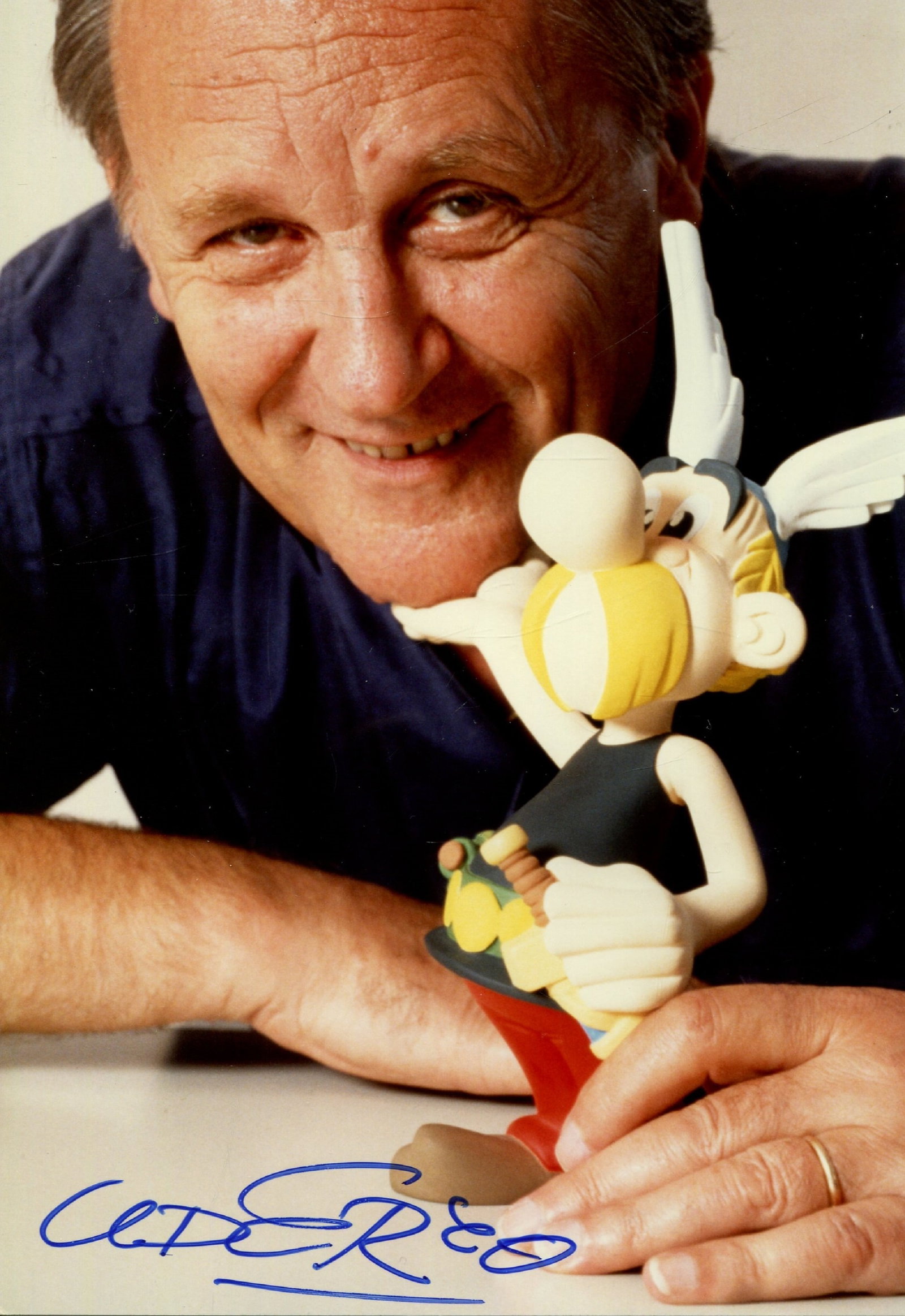 UDERZO ALBERT: (1927-2020): UDERZO ALBERT: (1927-2020) French comic book Artist. Best known for his comic book series Asterix in collaboration with René Goscinny. Colour signed 4.5 x 7 photograph `Uderzo´, the image