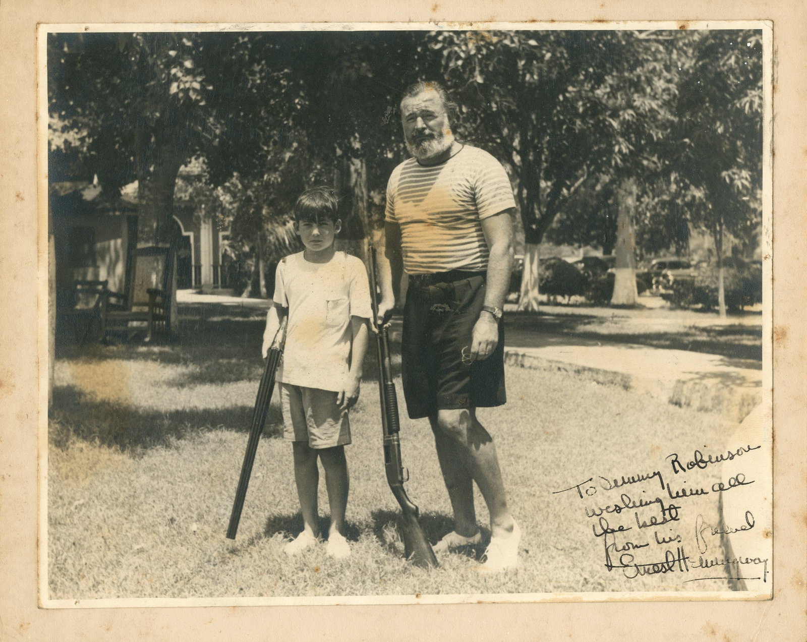 HEMINGWAY ERNEST: (1899-1961): HEMINGWAY ERNEST: (1899-1961) American novelist, Nobel Prize winner for Literature, 1954. Vintage signed and inscribed 9.5 x 7.5 photograph of Hemingway standing outdoors in a full-length pose on a