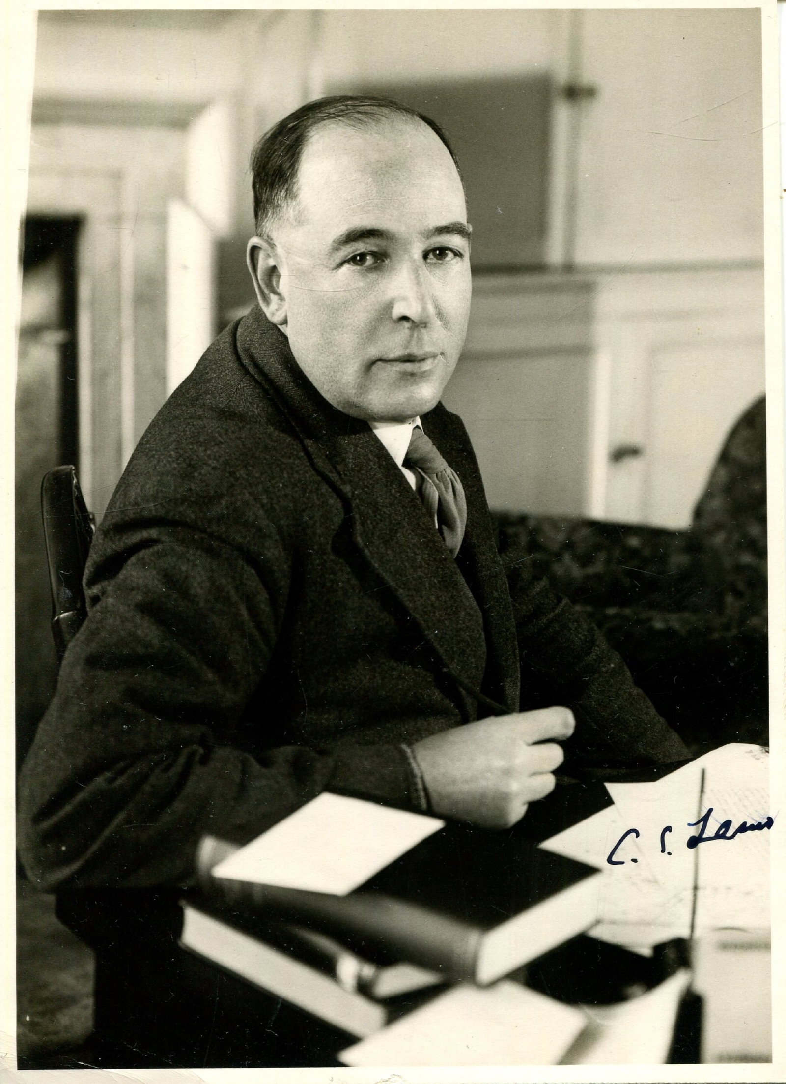 LEWIS C. S: (1893-1963): LEWIS C. S: (1893-1963) Irish novelist & academic, author of The Chronicles of Narnia. A fine vintage signed 4.5 x 6 photograph, an engaging image of the writer seated in a half-length pose at
