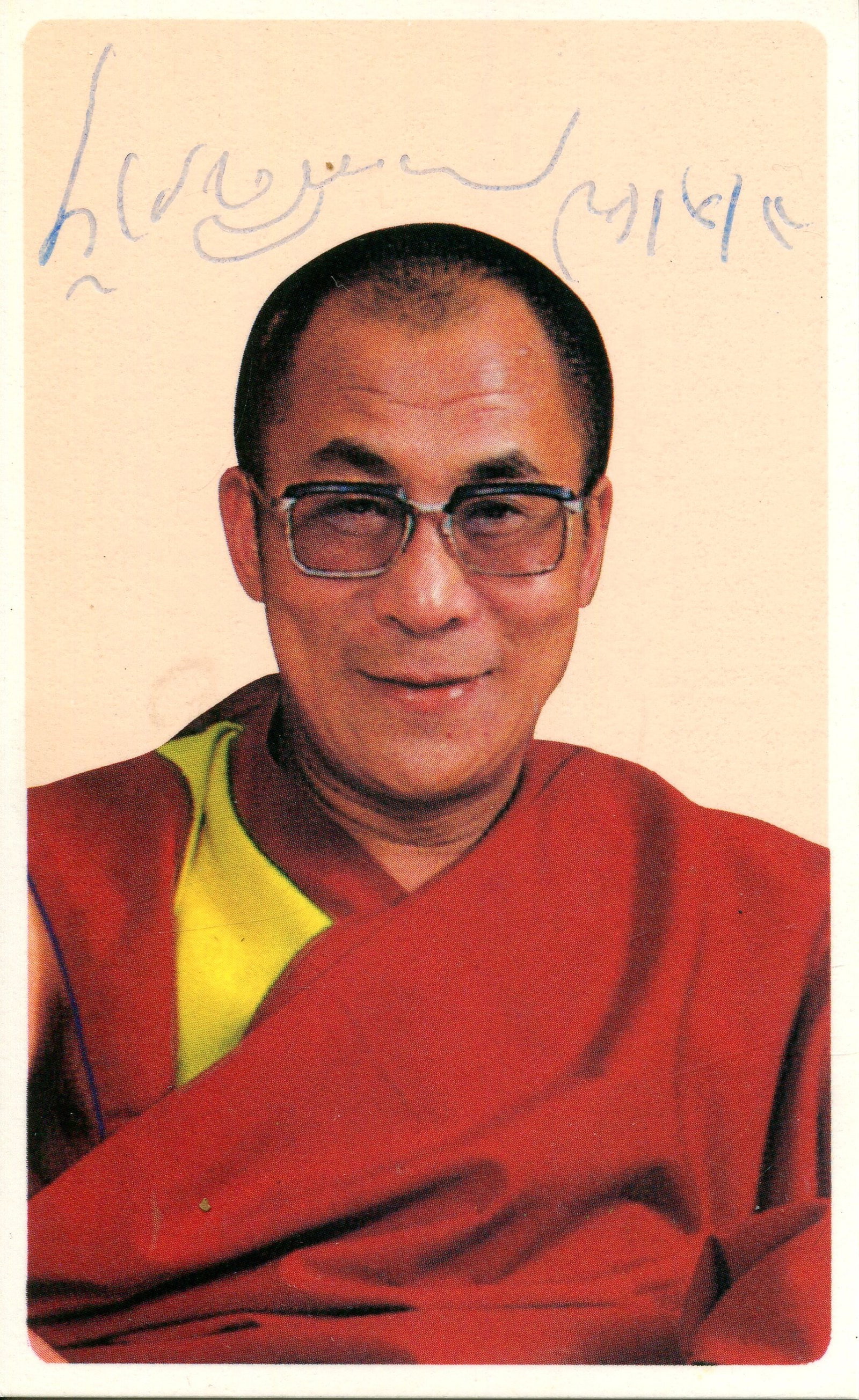 DALAI LAMA: (1935- ): DALAI LAMA: (1935- ) Tibetan spiritual leader, Nobel Peace Prize winner, 1989. Signed colour 2.5 x 4.5 photograph of the Dalai Lama in a head and shoulders pose wearing his familiar Buddhist robes.