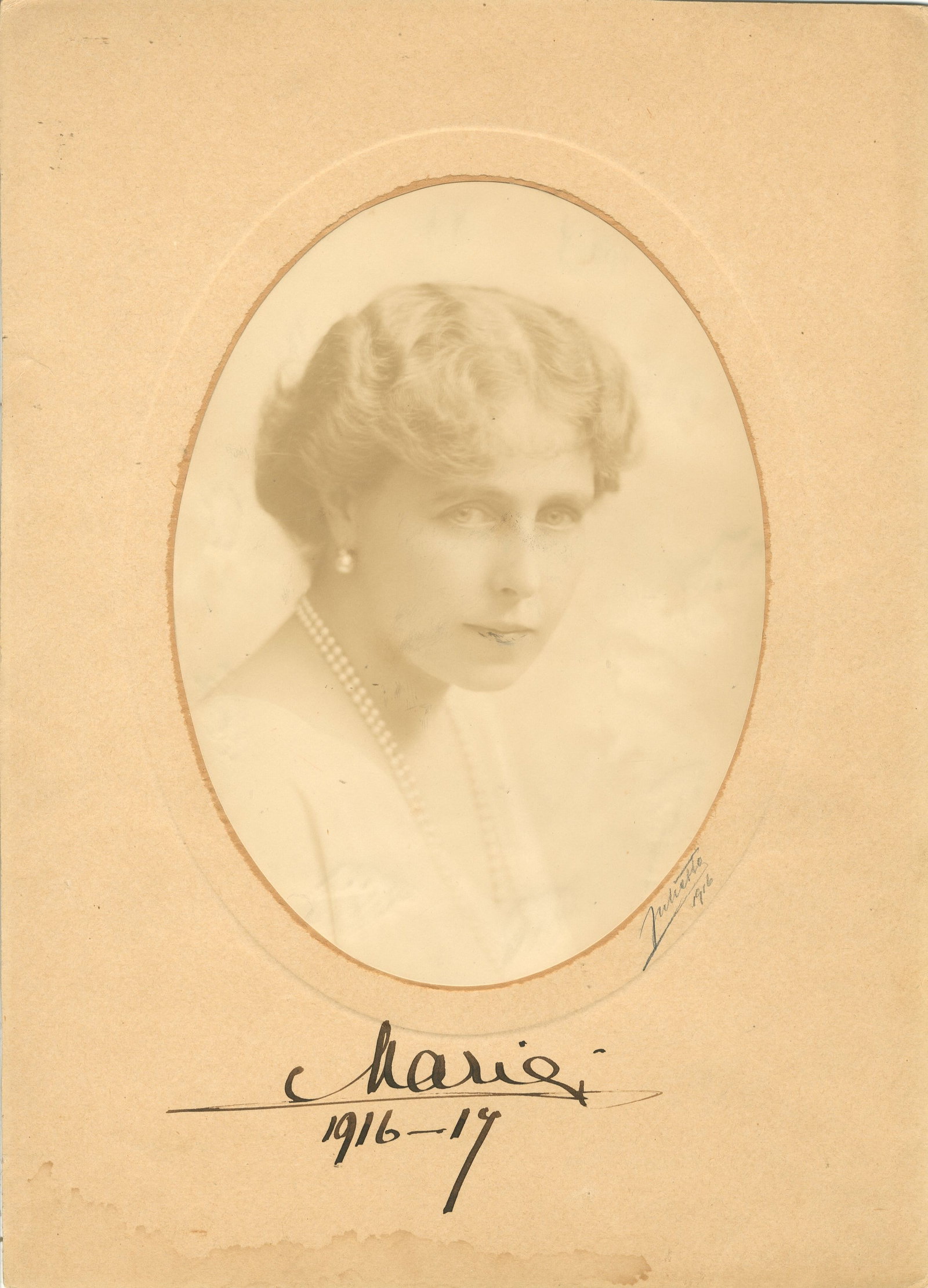 MARIE OF ROMANIA: (1875-1938): MARIE OF ROMANIA: (1875-1938) British Princess who served as the last Queen of Romania (1914-27) as the consort of King Ferdinand I. A good, large vintage signed 10 x 14 photograph, the sepia oval