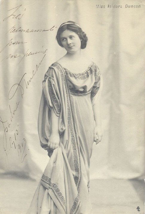DUNCAN ISADORA: (1877-1927) American Dancer. Rare: DUNCAN ISADORA: (1877-1927) American Dancer. Rare vintage signed postcard photograph of the elegant Duncan standing in a full length pose. Signed ('Isadora Duncan') in fountain pen ink to a light area