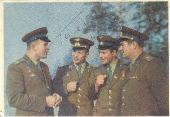 GAGARIN YURI: (1934-1968) Russian Cosmonaut, the first: GAGARIN YURI: (1934-1968) Russian Cosmonaut, the first man to travel in space, 1961. Vintage signed colour 6 x 4 postcard photograph of Gagarin standing in a half length pose alongside three other cos
