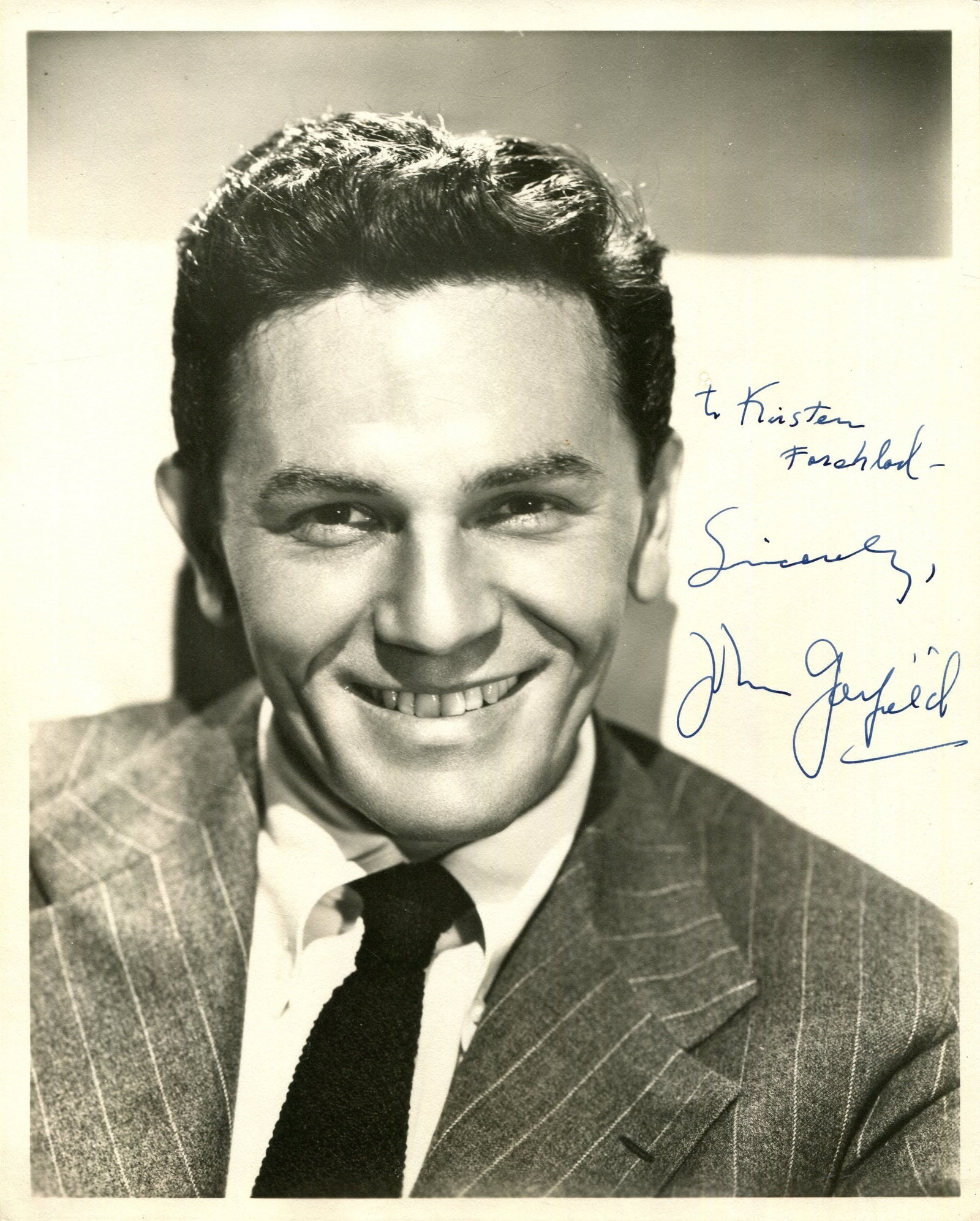 GARFIELD JOHN: (1913-1952): GARFIELD JOHN: (1913-1952) American actor. A scarce vintage signed and inscribed 8 x 10 photograph of Garfield seated in a smiling head and shoulders pose. Signed in bold blue fountain pen ink across