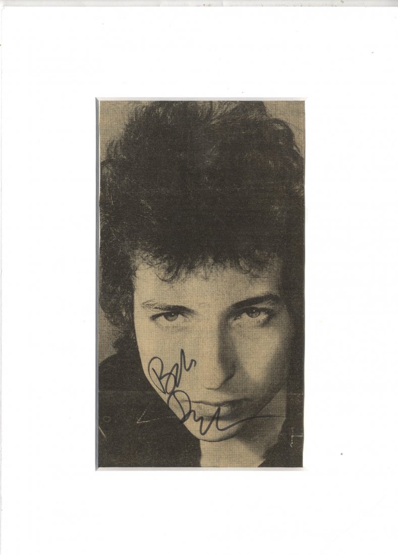DYLAN BOB: (1941- ) American Musician. Vintage sign: DYLAN BOB: (1941- ) American Musician. Vintage signed 4 x 7.5 newspaper photograph of Dylan in a close-up portrait pose. Signed in bold black ink with his name alone to a light area of the image. Matt
