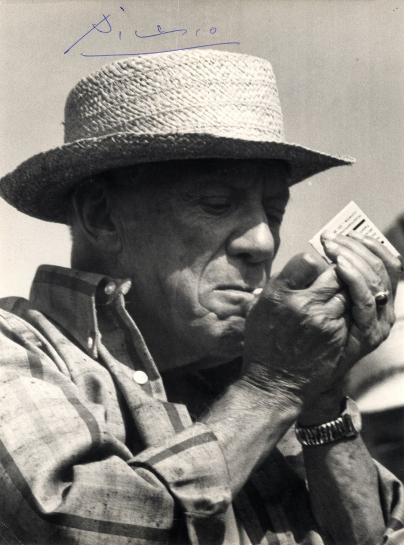 PICASSO PABLO: (1881-1973) Spanish Painter. An: PICASSO PABLO: (1881-1973) Spanish Painter. An excellent vintage signed 7 x 9.5 photograph, being a head and shoulders study of the painter outdoors, with his hands cupped around a cigarette in his mo
