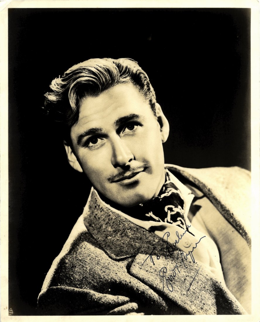 FLYNN ERROL: (1909-1959) Australian Actor. Vintage: FLYNN ERROL: (1909-1959) Australian Actor. Vintage signed and inscribed sepia 8 x 10 photograph depicting the dashing Flynn in a head and shoulders pose wearing a cravat and jacket. Signed in blue fou