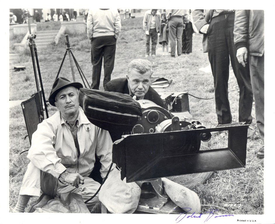 ROSSEN ROBERT: (1908-1966) American Film Director of: ROSSEN ROBERT: (1908-1966) American Film Director of All the King´s Men (1949) and The Hustler (1961). Vintage Signed 10 x 8 photograph depicting Rossen seated on the ground behind a large camera sho