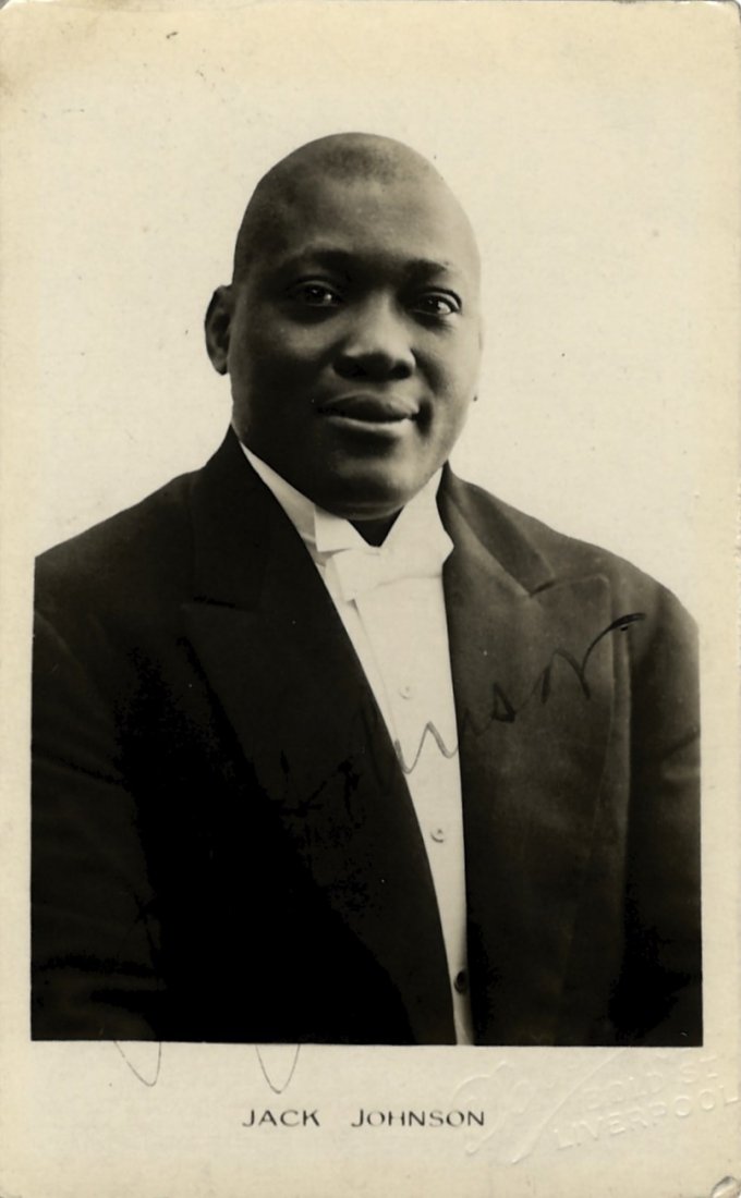 JOHNSON JACK: (1878-1946) American Boxer, World: JOHNSON JACK: (1878-1946) American Boxer, World Heavyweight Champion 1908-15. Rare, vintage signed postcard photograph of Johnson in a head and shoulders pose. Signed ('Jack Johnson') in fountain pen