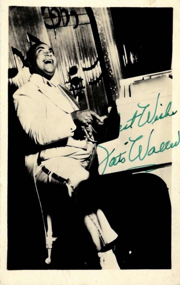 WALLER THOMAS 'FATS': (1904-1943) American Jazz: WALLER THOMAS 'FATS': (1904-1943) American Jazz Pianist. Vintage signed postcard photograph of Waller seated in a full length pose enthusiastically playing his piano. Signed ('Fats Waller') in bold gr
