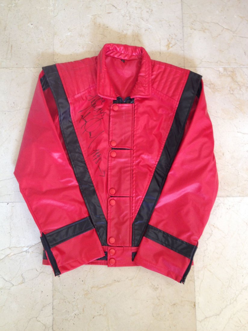 JACKSON MICHAEL: (1958-2009) American Pop Singer. A: JACKSON MICHAEL: (1958-2009) American Pop Singer. A black and red jacket, of a design similar to that worn by the singer in his famous Thriller video, signed ('Love always, Michael Jackson') in bold b