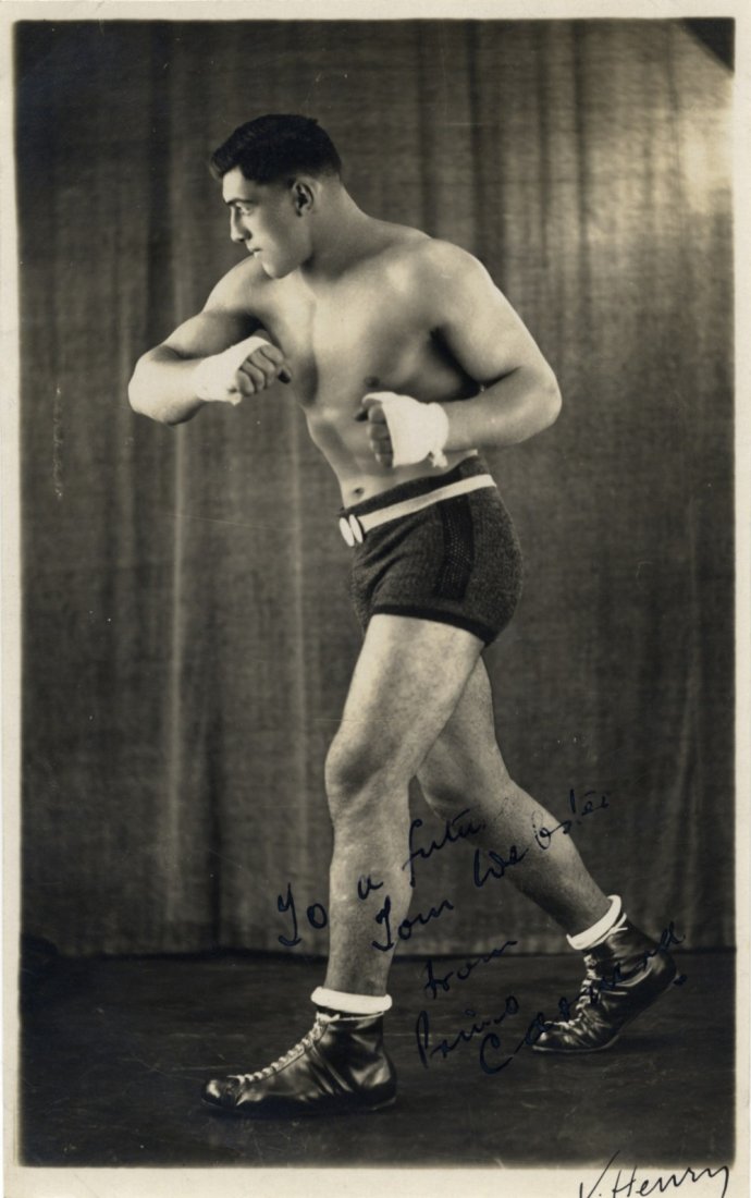 CARNERA PRIMO: (1906-1967) Italian Boxer, World: CARNERA PRIMO: (1906-1967) Italian Boxer, World Heavyweight Champion 1933-34. Vintage signed and inscribed 5.5 x 9 photograph, a good image of Carnera standing in a full length profile boxing pose. Ph