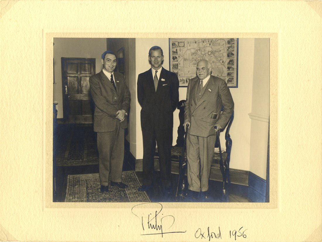 PRINCE PHILIP: (1921- ) Duke of Edinburgh, husband and: PRINCE PHILIP: (1921- ) Duke of Edinburgh, husband and consort of Queen Elizabeth II. Vintage signed 12 x 9 photograph of Prince Philip standing in a full length pose at the centre of two gentlemen, t