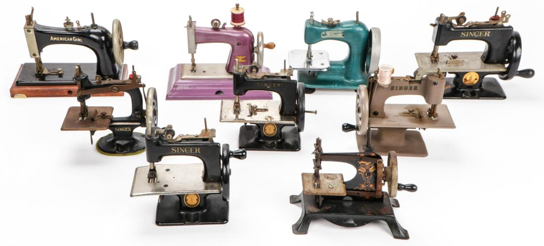 Group of 9 Vintage Mini Sewing Machines: Group of 9 Vintage Miniature Toy Sewing Machines, various manufacturers including Singer, Casige, American Girl, and Stitch Mistress. Largest: 7'' x 5'' x 8.75'' (18 x 13 x 22 cm).