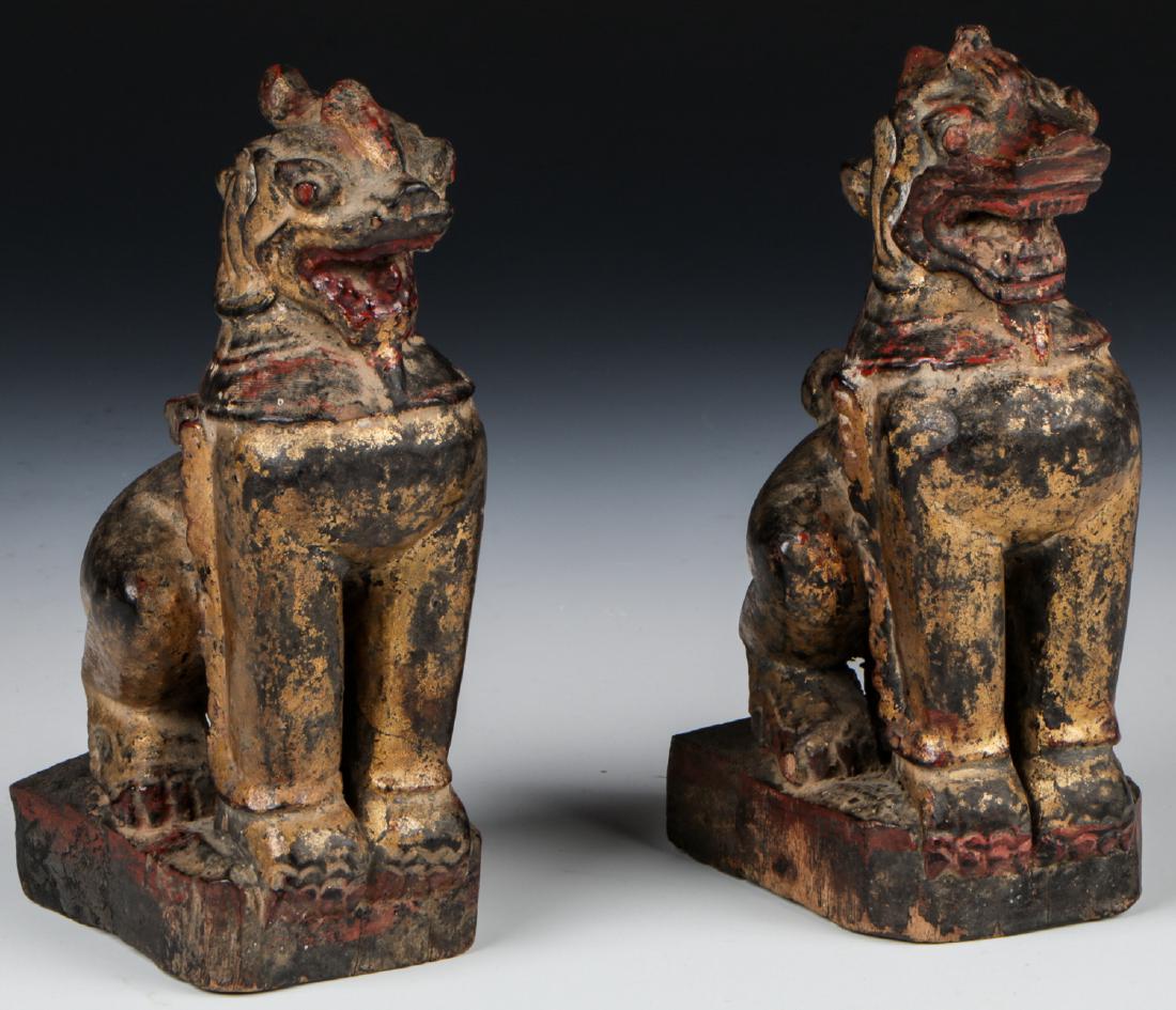 Pair of Antique Burmese Gilt Foo Dogs: Pair of Antique Burmese Gilt Foo Dogs, carved wood, gilt, traces of old paint. Each size: 8'' x 3.5'' x 4'' (20 x 9 x 10 cm).