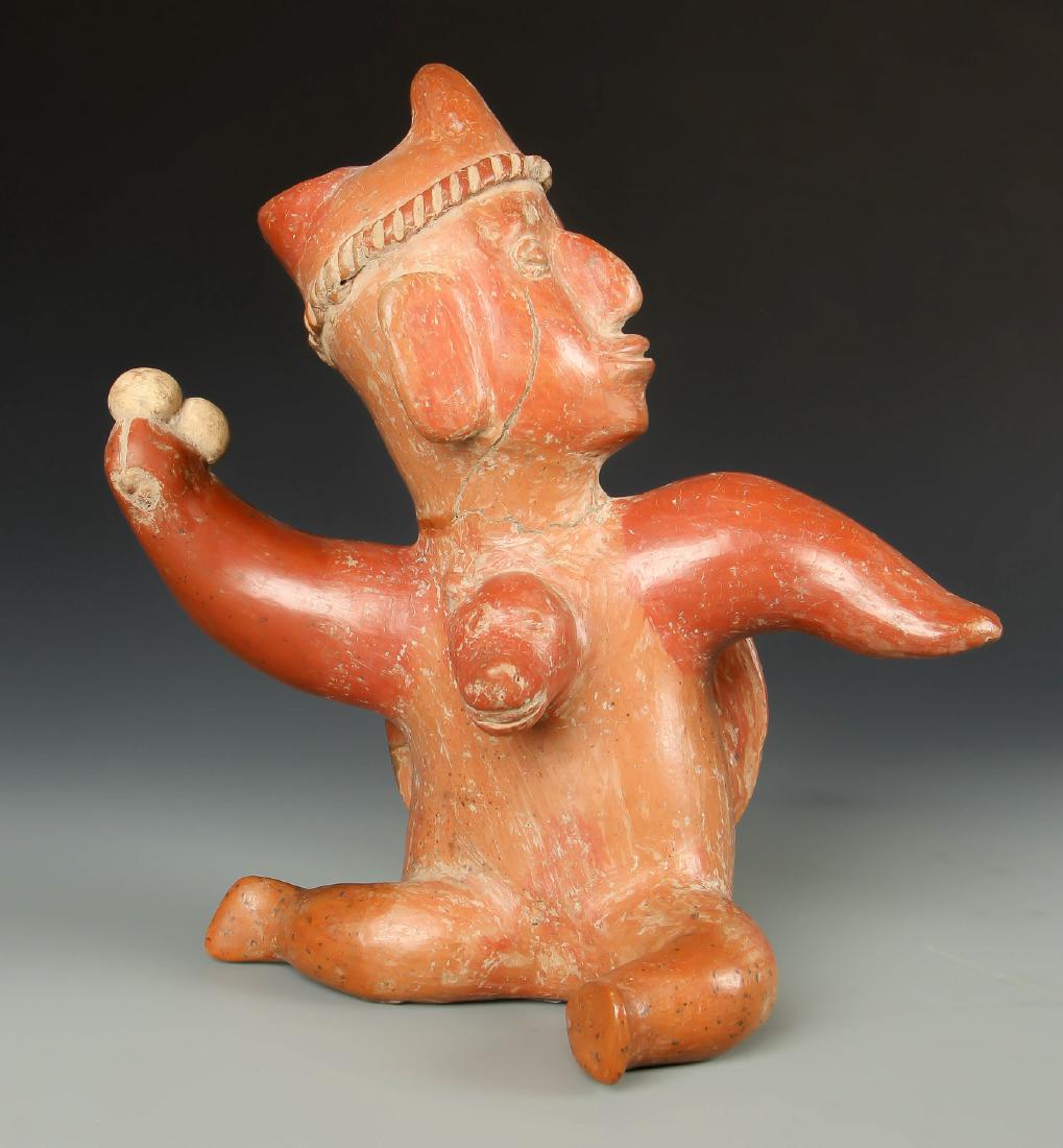 Colima Shaman in Mid Transformation w Dog Head, 200 BCE: Pre-Columbian Redware Colima Shaman in Mid Transformation w Dog Head, 200 BCE - 200 CE, Mexico. Size: 10'' x 9.75'' x 5'' (25 x 25 x 13 cm). Ex Collection/Estate Geraldine Ring, Princeton, NJ. Collect