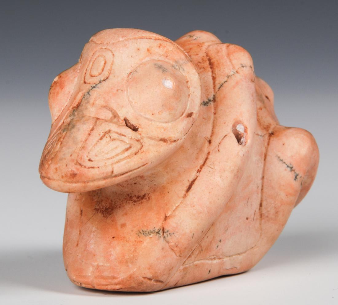 Taino Anthropo-Zoomorphic Cemi (1000-1500 CE): Taino Anthropo-Zoomorphic Cemi (1000-1500 CE), in reptilian transition, made of pinkish hardstone. 1.5'' x 1'' x 2.25'' (4 x 3 x 6 cm). Provenance: Larry Roberts, author of Taino Sculpture: Art of the