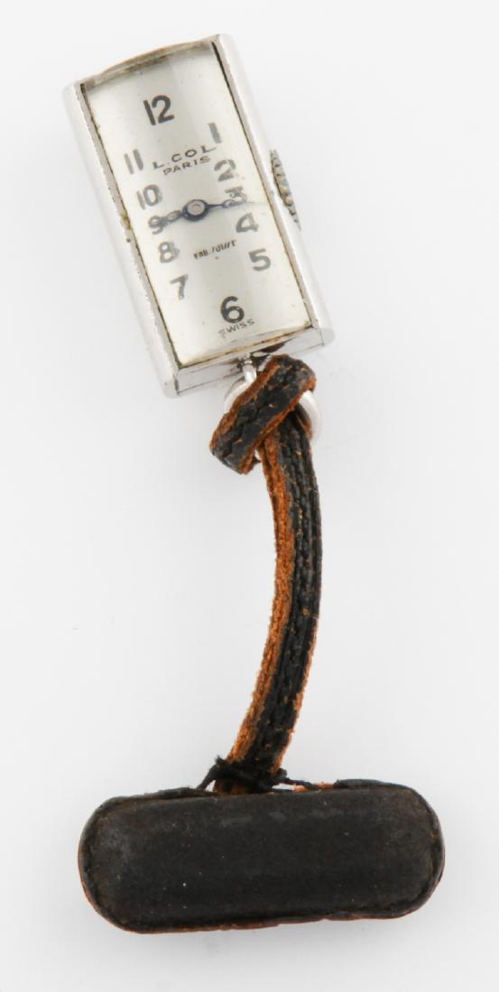 Nickel Silver Watch Pin on Leather Cord marked Juvenia: Nickel Silver Watch Pin on Leather Cord marked Juvenia Mfg Swiss. Size: 1"H (3 cm). Provenance: Ex Doris Duke Collection. 13.7 g.