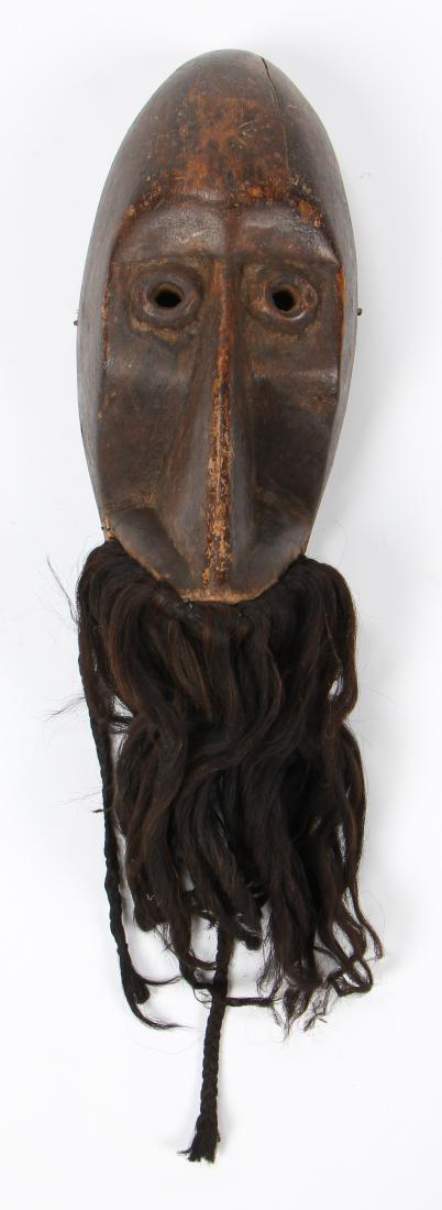 Simian Mask, Dan Peoples, Liberia, Early 20th C.: Simian mask, gagon, with monkey fur whiskers, Dan peoples, Liberia, early 20th c. Carved wood, hair.Size: 20'' x 6'' x 5'' (51 x 15 x 13 cm). Provenance: The Estate of Mary Bert Gutman, Pennsylvania.