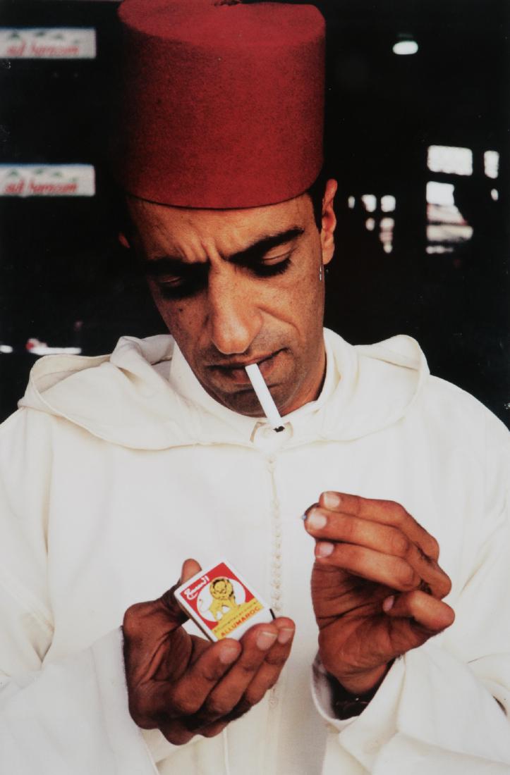 Hassan Hajjaj (Moroccan, b. 1961) "Ahmed Lighting Up": Hassan Hajjaj (Moroccan, b. 1961) "Ahmed Lighting Up", 2000. Epson Luster Print on Aluminum. Size: 19.75'' x 13'' (50 x 33 cm). Exhibition Photograph from "Africa: See You, See Me". Provenance: Privat