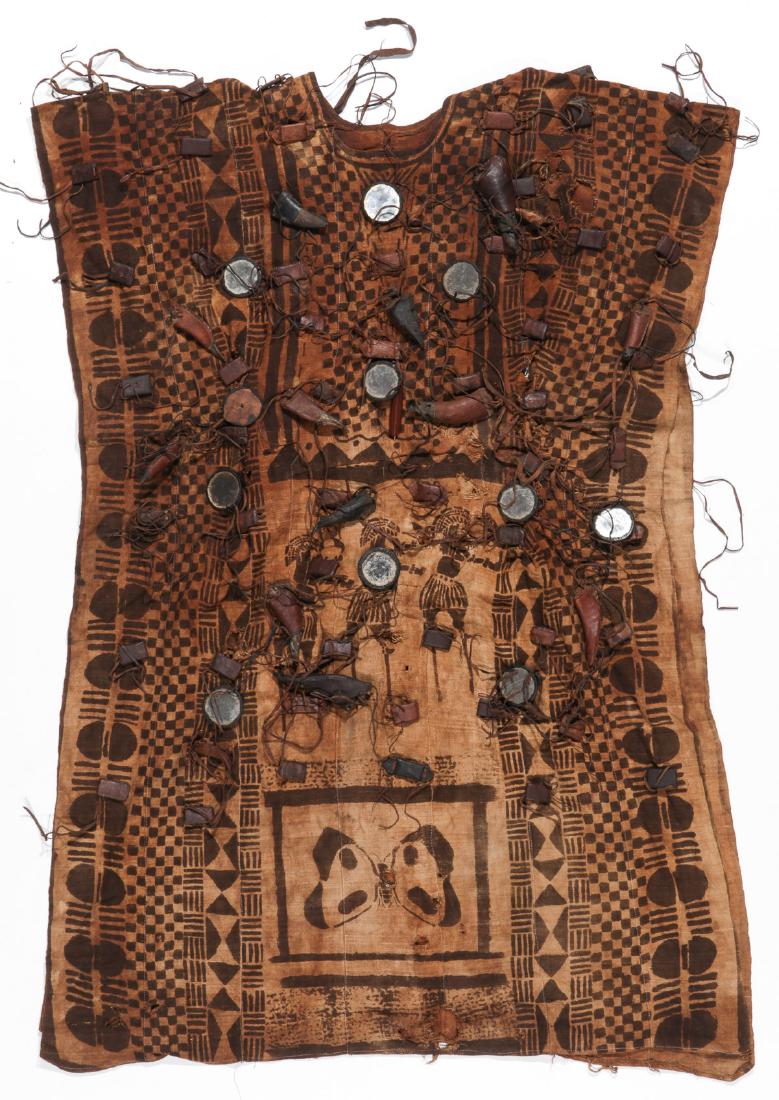 Hunter's Shirt, Bamana People, Mali: Hunter's Shirt, Bamana People, Mali. Hand-spun cotton, narrow strip cloth, various attached talismans. Mid 20th c. Size: 52'' x 38'' (132 x 97 cm).