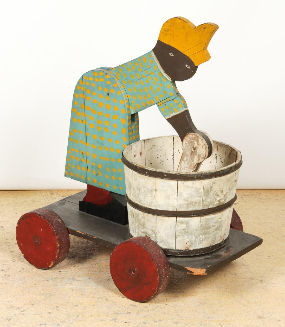 Folk Art Automated Washer Woman Trade Shop Sign or Toy: Antique Folk Art Automated Washer Woman Trade Shop Sign or Toy. Found in Florida in the early 20th c. Carved and painted wood. As wheels turn, the woman motions forward and back scrubbing laundry. Siz