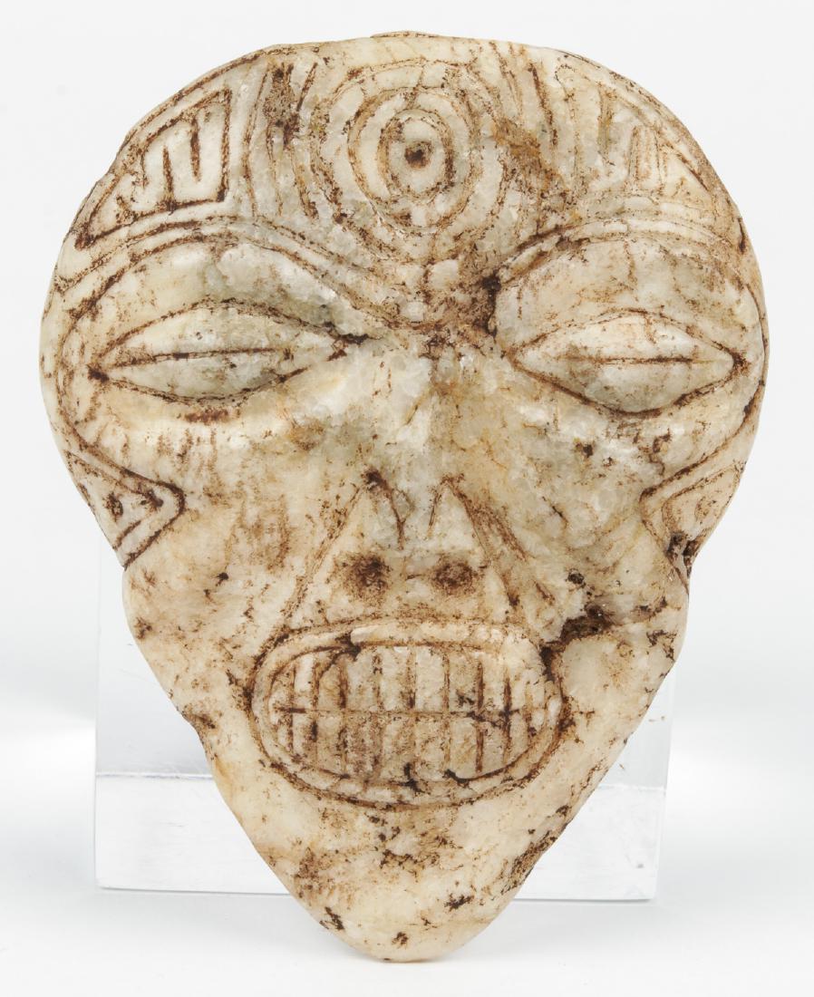 Taino Marble Mask (1000-1500 CE): Taino Marble Mask (1000-1500 CE). Closed eyes suggest trance state. Centric circle on forehead forms 2 bird heads with water symbols on beaks. Provenance: Larry Roberts, author of Taino Sculpture: Art