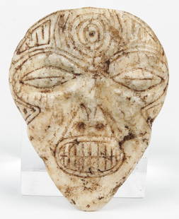 Taino Marble Mask (1000-1500 CE): Taino Marble Mask (1000-1500 CE). Closed eyes suggest trance state. Centric circle on forehead forms 2 bird heads with water symbols on beaks. Provenance: Larry Roberts, author of Taino Sculpture: