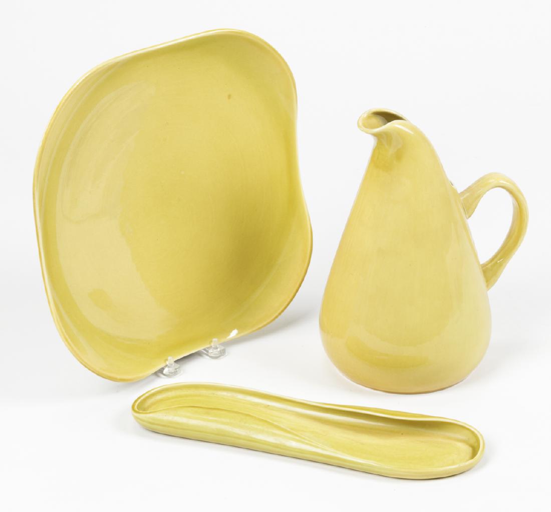 3 pc Russel Wright American Modern Ceramic Lot: 3 pc Russel Wright American Modern Ceramic Lot: Chartreuse Pitcher, Chop Platter and Celery Dish. Ranging in size from: 12.5" (32 cm) diameter to 1'' x 3.5'' x 13'' (3 x 9 x 33 cm).