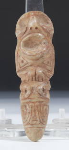 Taino Full Figure Anthropic Vomit Stick (1000-1500 CE): Taino Full Figure Anthropic Vomit Stick (1000-1500 CE). Elaborate symbolic band under figure legs. Distended ribs carved on back. Made of marble. Size: 1'' x 1.25'' x 4'' (3 x 3 x 10 cm). Provenance: