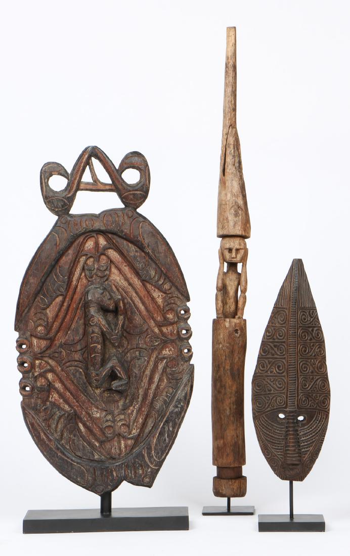 3 East Indonesian Tribal Mask & Sculptures: 3 East Indonesian Tribal Mask & Sculptures. Ranging in size from: 16.25'' x 5.75'' x 1.75'' (41 x 15 x 4 cm), height on stand: 20" (51 cm) to 26'' x 13'' x 1.75'' (66 x 33 x 4 cm), height on stand: 28