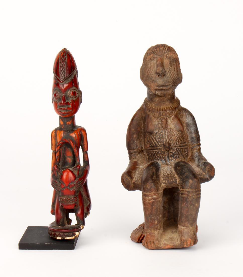 Two African Items: Two African Items. Comprising a terracotta pipe and an Owo bone figure. Largest size: 7'' x 3.5'' x 4.5'' (18 x 9 x 11 cm).