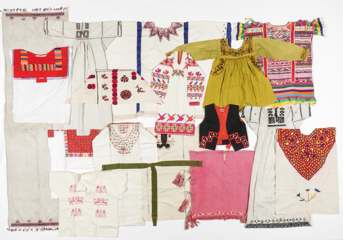Large Lot of Folk Textiles: Large Lot of Antique and Vintage Folk Textiles in cotton and linen, Latin American and Eastern European/Russian including 10 heavily embroidered huipil and dresses from Guatemala and Mexico and two dr